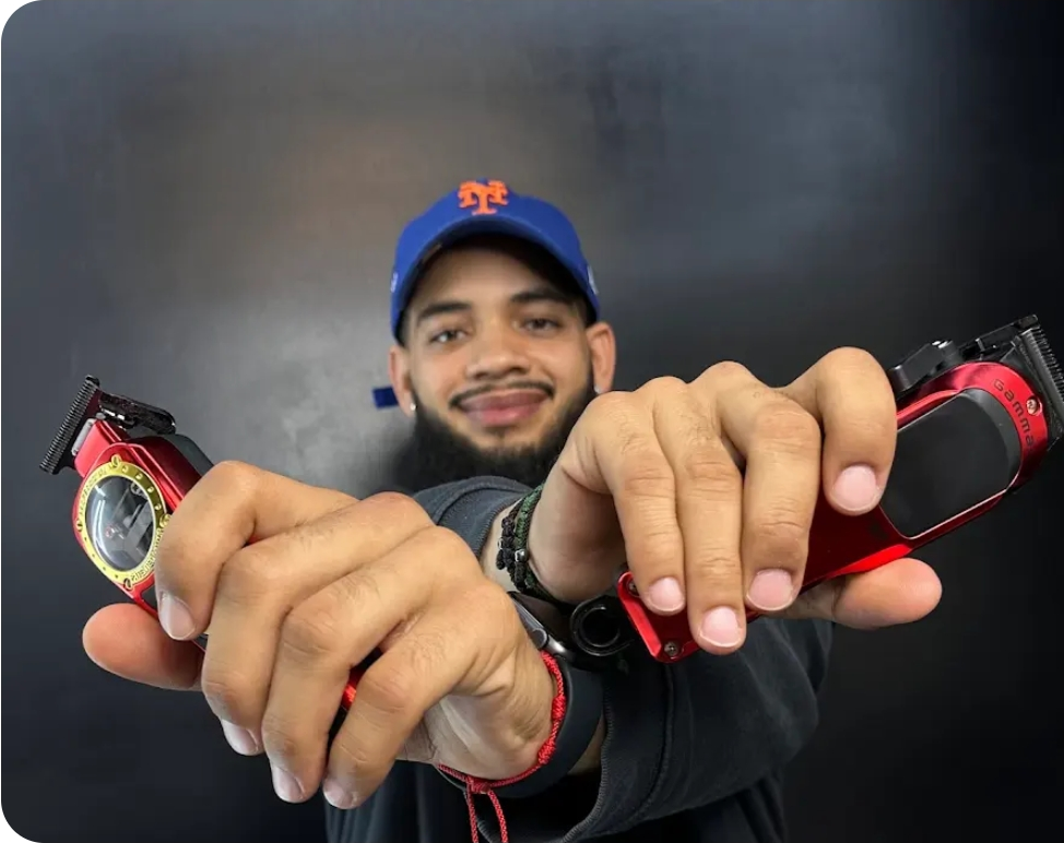 J De La Cruz, master barber and owner of JCRUZ STYLEZ, holding his clippers